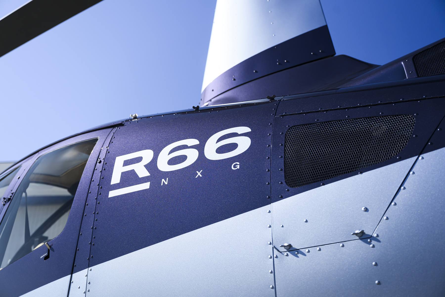 Robinson R66 NxG fuselage detail against a clear sky