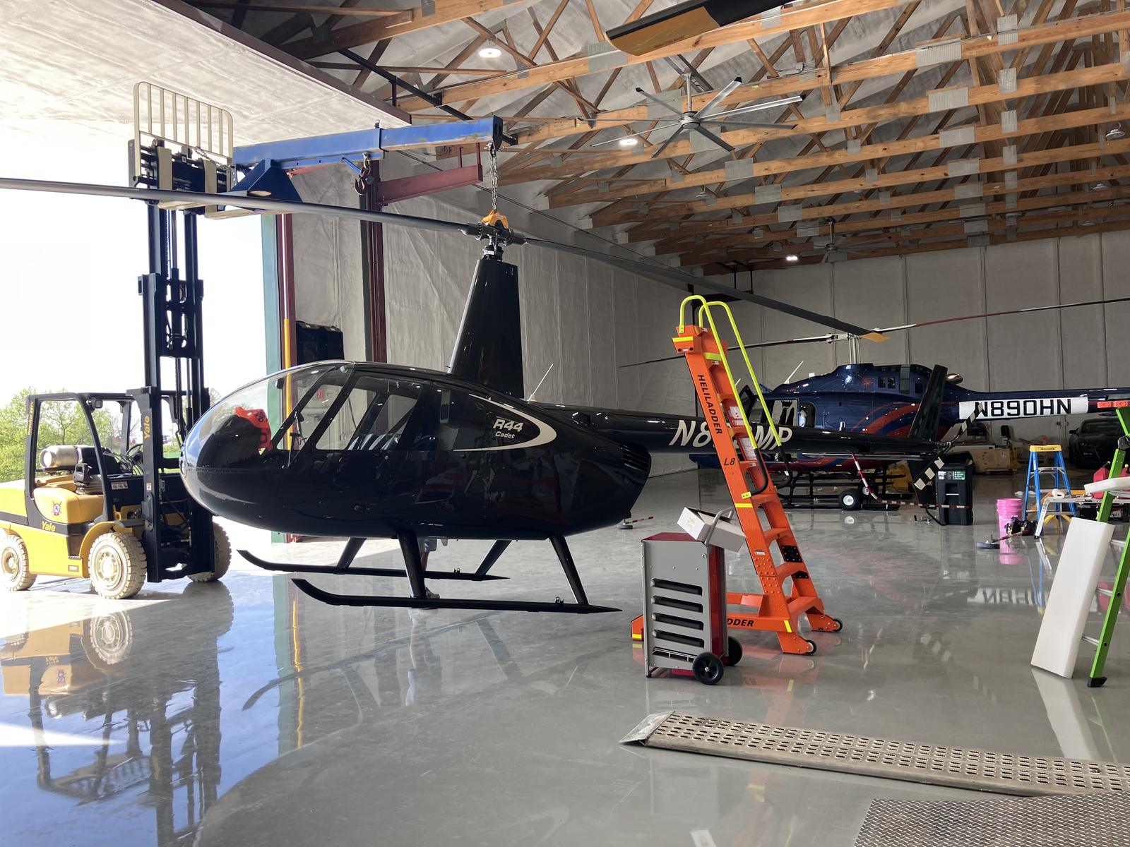Robinson R44 Cadet on a lift in Castle's maintenance hangar